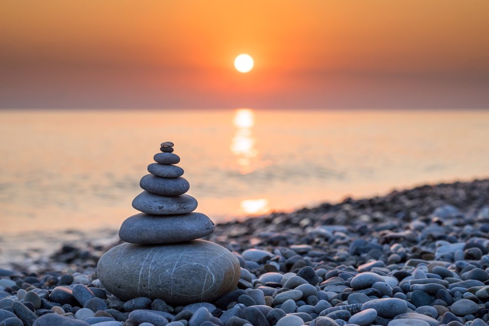 pyramidofstonesformeditationlyingonseacoastat